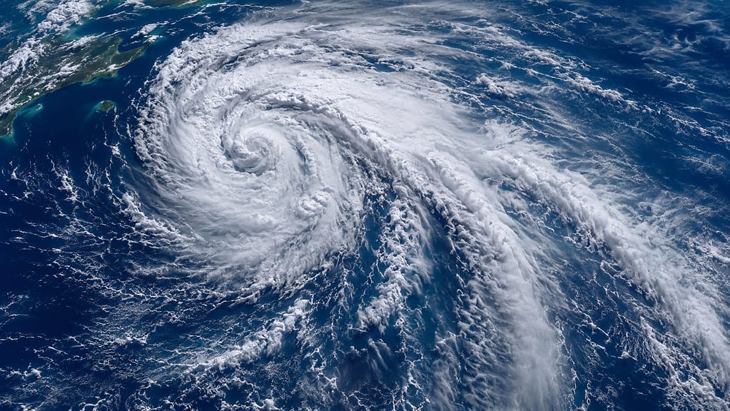 Massive Atlantic Ocean storm system viewed from above with spiraling cloud bands over deep blue water