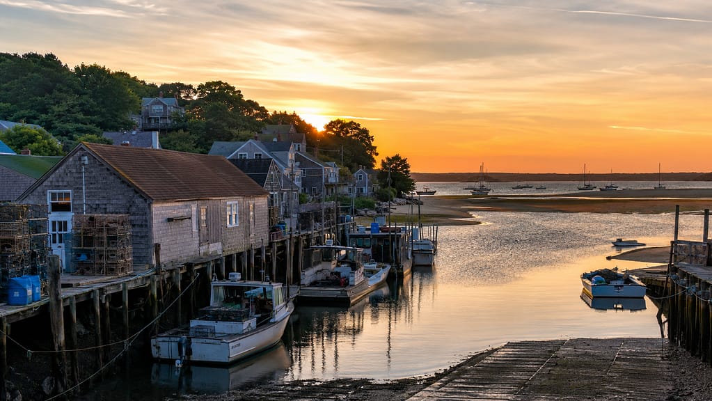 Wellfleet Harbor at sunset with oyster boats and Cape Cod Bay views