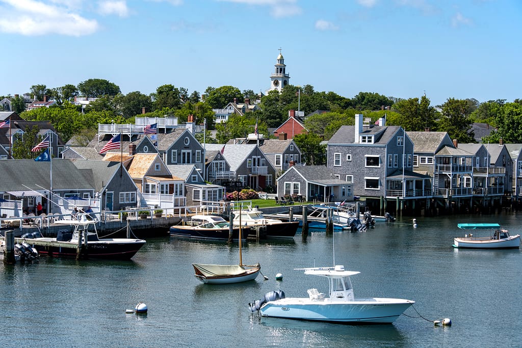 Nantucket Harbor with sailboats, cobblestone waterfront, and historic cedar-shingle buildings during summer