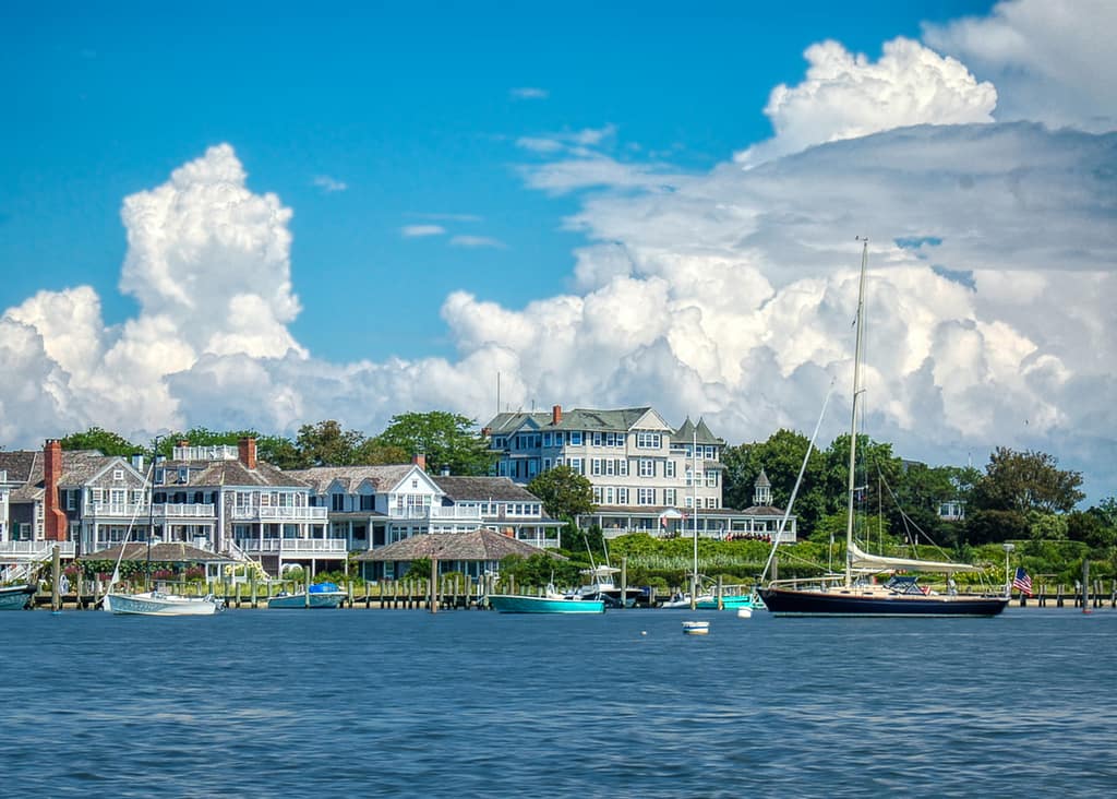 Edgartown Harbor at sunset with sailboats and classic Martha’s Vineyard coastal homes
