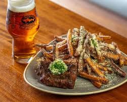 dogfish brew pub rehoboth beach delaware loaded fries and beer